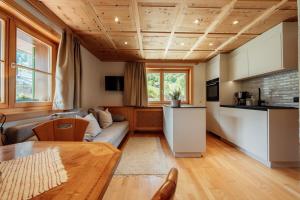 a living room with a couch and a table at Faneskla Apartments in Silbertal