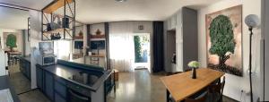 a living room with a table and a kitchen at Villa Karabelli in Búč +46 photos