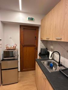 a kitchen with a sink and a counter top at Prime 27 Luxury Studio in Lavrio