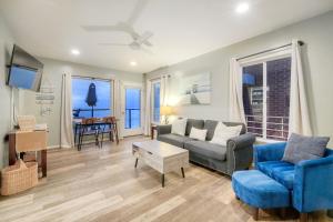 a living room with a couch and a table at Oceanfront unit, Private Balcony, Beach Access, Sunset Views in Carlsbad