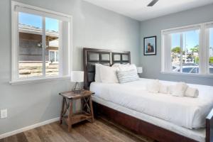a bedroom with a large bed and a window at Oceanfront unit, Private Balcony, Beach Access, Sunset Views in Carlsbad
