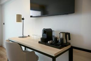 a room with a table with a coffee maker on it at Sercotel Cruz Del Mar in Chipiona +53 photos