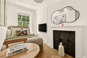 a bedroom with a bed and a fireplace at GuestReady - The Crescent in London +115 photos