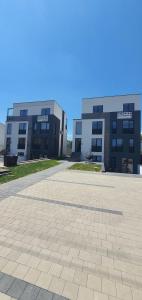 a large building with a parking lot in front of it at ApartHotel NoahResidence in Alba Iulia