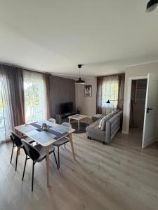 a living room with a table and a couch at Apartament 9 Rydzyna in Rydzyna