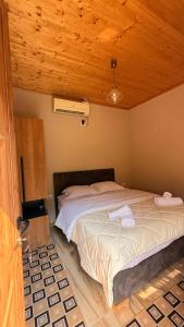 a bedroom with a bed with two towels on it at - Cemi Rooms - River View & Traditional Restaurant in Tamarë