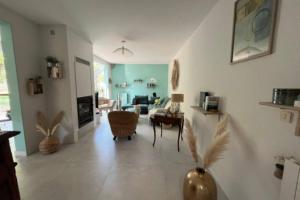 a living room with a couch and a table at Maison avec jardin & proche plages in Saint-Jean-de-Védas