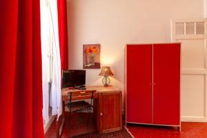 a red desk with a computer and a red cabinet at Chambres D'hôtes Chez Marie in Marseille