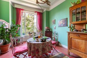 a table and chairs in a room with green walls at Chambres D'hôtes Chez Marie in Marseille