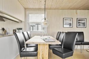 a dining room with a table and leather chairs at LN76217-Hjorring-Hjaelmerenden-2 in Hjørring +11 photos
