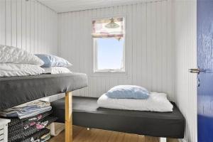 a room with two bunk beds and a window at LN76217-Hjorring-Hjaelmerenden-2 in Hjørring