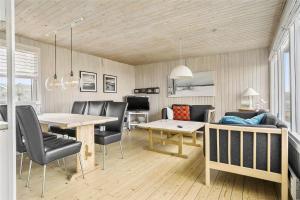 a living room with a table and a couch at LN76217-Hjorring-Hjaelmerenden-2 in Hjørring