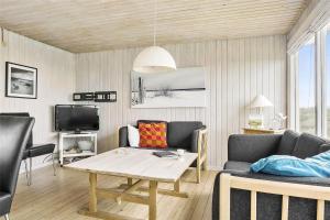 a living room with a couch and a table at LN76217-Hjorring-Hjaelmerenden-2 in Hjørring
