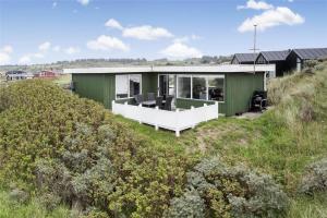 a green house on top of a hill at LN76217-Hjorring-Hjaelmerenden-2 in Hjørring