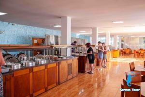 a group of people in a kitchen preparing food at Hotel Carmen Tower - Balada in Saturn