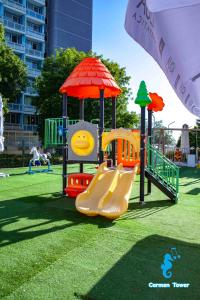 a playground with a slide in a park at Hotel Carmen Tower - Balada in Saturn