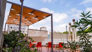 a patio with a table and chairs under a canopy at Altezza Apart Suites in Mendoza