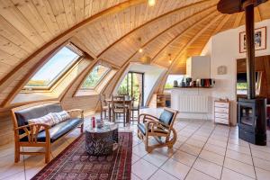 a large living room with a large arched ceiling at Les Dômes Du Ponant in Plouguerneau