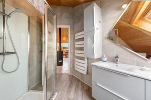 a bathroom with a shower and a sink at Les Dômes Du Ponant in Plouguerneau