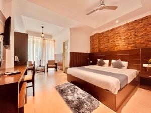a bedroom with a bed and a desk and a brick wall at Matha Residency in Kasauli +55 photos