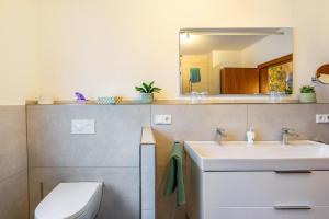 a bathroom with a sink and a toilet at Schillings Häusken in Brilon +37 photos
