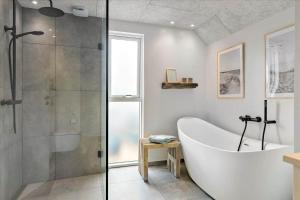 a bathroom with a tub and a glass shower at LN1842-Hjorring-Lobet-5 in Hjørring +20 photos