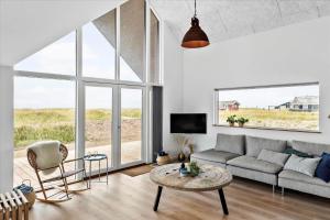 a living room with a couch and a table at LN1842-Hjorring-Lobet-5 in Hjørring