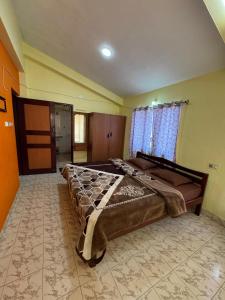 a bedroom with a large bed in a room at DD cottages in Ooty +7 photos