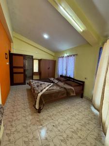 a large bedroom with a bed in the middle of it at DD cottages in Ooty