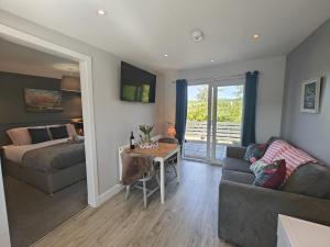 a living room with a couch and a table at Jack's Hideaway in Gatehouse of Fleet