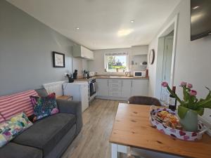 a living room with a couch and a table at Jack's Hideaway in Gatehouse of Fleet