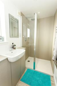 a white bathroom with a sink and a shower at Jack's Hideaway in Gatehouse of Fleet +33 photos
