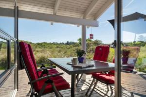 a table and chairs on a deck with a view at LN674-Hjorring-Rodspaettevej-16 in Hjørring