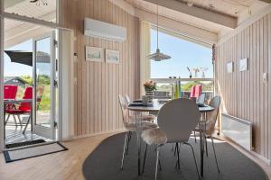 a dining room with a table and chairs and a balcony at LN674-Hjorring-Rodspaettevej-16 in Hjørring +18 photos