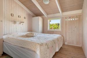a bedroom with a bed in a room with a window at LN674-Hjorring-Rodspaettevej-16 in Hjørring