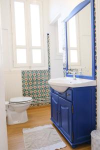 a bathroom with a blue sink and a toilet at VILLA treize quartier balnéaire in Mers-les-Bains