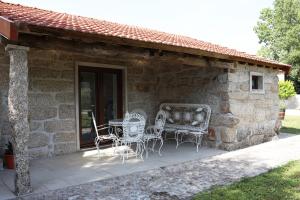 a patio with chairs and a table in front of a building at Retiro Maria Idalina in Amarante