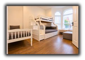 a bedroom with two bunk beds and a window at Kop View Rooms in Liverpool +72 photos