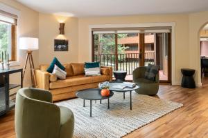 a living room with a couch and chairs and a table at Winter Park Place #1 in Winter Park