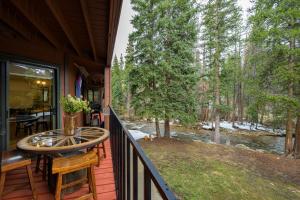 a porch with a table and a view of a river at Winter Park Place #1 in Winter Park