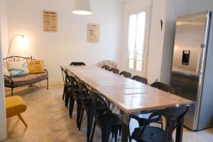 a room with a long table with chairs and a refrigerator at VILLA treize quartier balnéaire in Mers-les-Bains