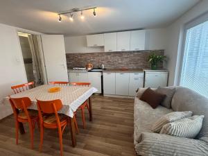 a living room with a table and a couch at Grand House in Štúrovo