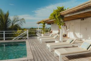 a deck with lounge chairs and a swimming pool at Villa Tomama by Preabeach Experience in Prea