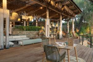an outdoor patio with a table and chairs at Saseka Tented Camp in Hoedspruit