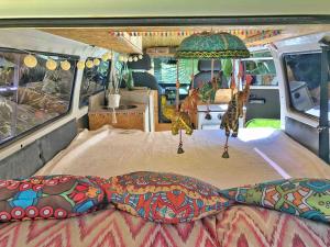 a bed in the back of a camper van at Zíngara - Kombi Home in Brumadinho