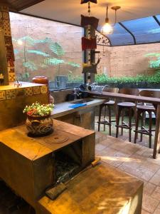 a restaurant with a table with a vase on it at Zíngara - Kombi Home in Brumadinho