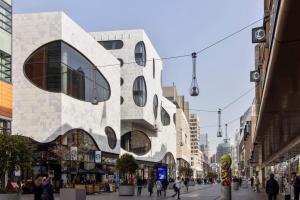a building on a street with people walking on the street at COVE Centrum in The Hague