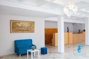 a room with a blue chair and a painting on the wall at Hotel Carmen Tower - Balada in Saturn +69 photos