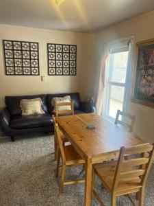 a living room with a wooden table and a couch at Historic Windsor in Silver Plume