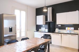 a kitchen with white cabinets and a table with chairs at VILLA treize quartier balnéaire in Mers-les-Bains +27 photos